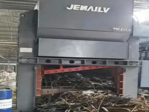 A guillotine shear being tested, with scrap metal in the cutting chamber